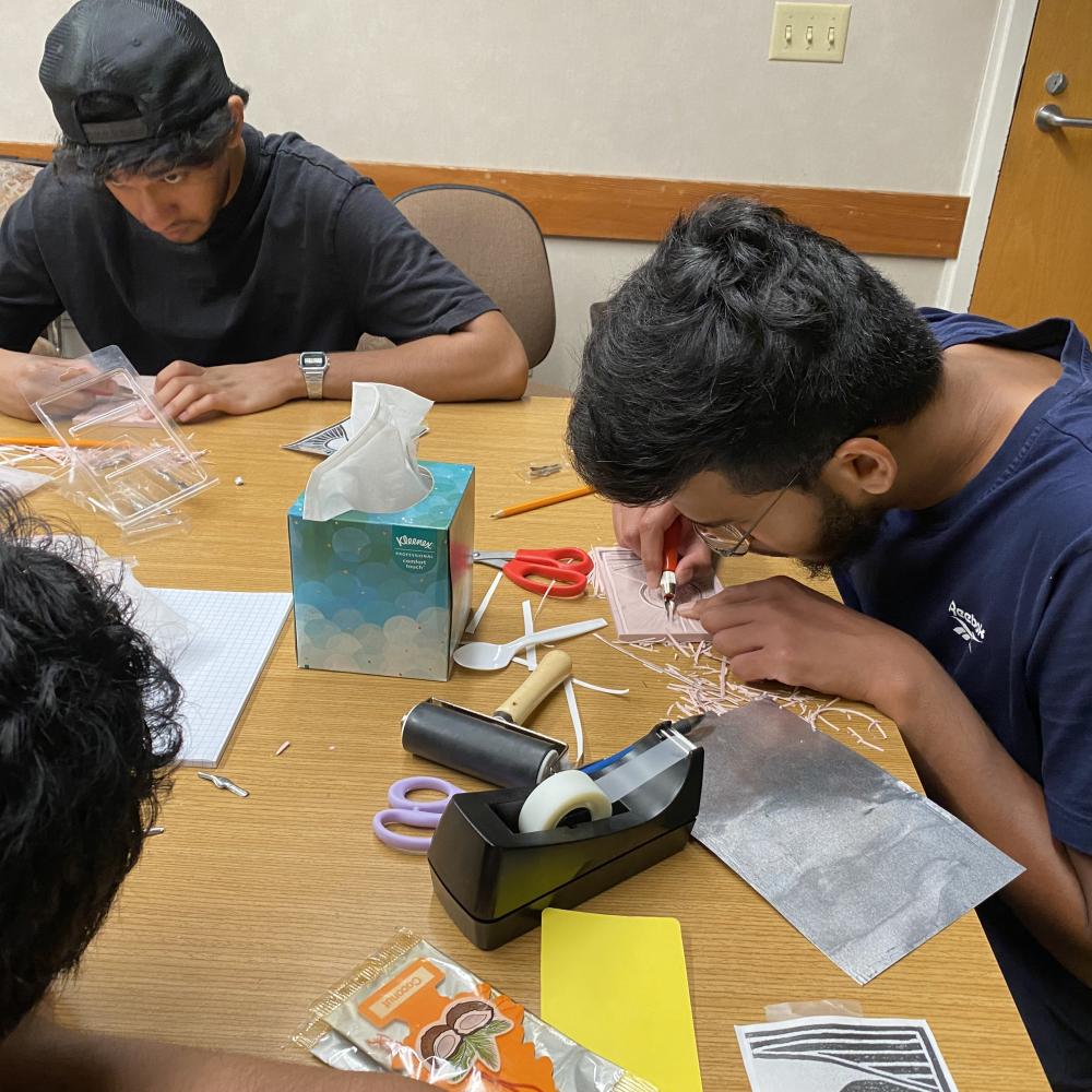 Student carving a rubber block for printmaking