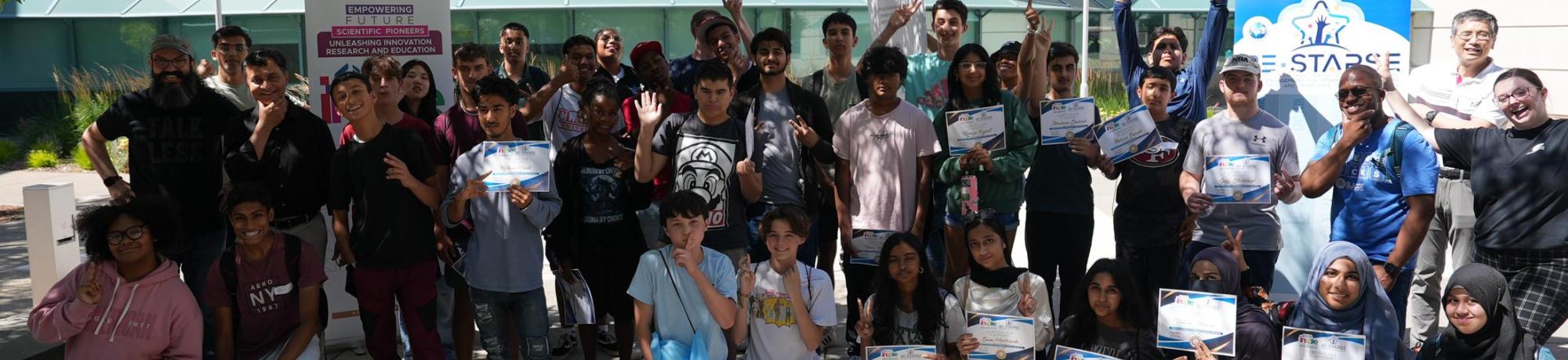 Group picture in front of Kemper Courtyard after completing the workshop with their certificates 